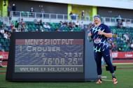 Ryan Crouser alongside the display board flashing his WR in shot put at US Olympic Track and Field Trials 2021